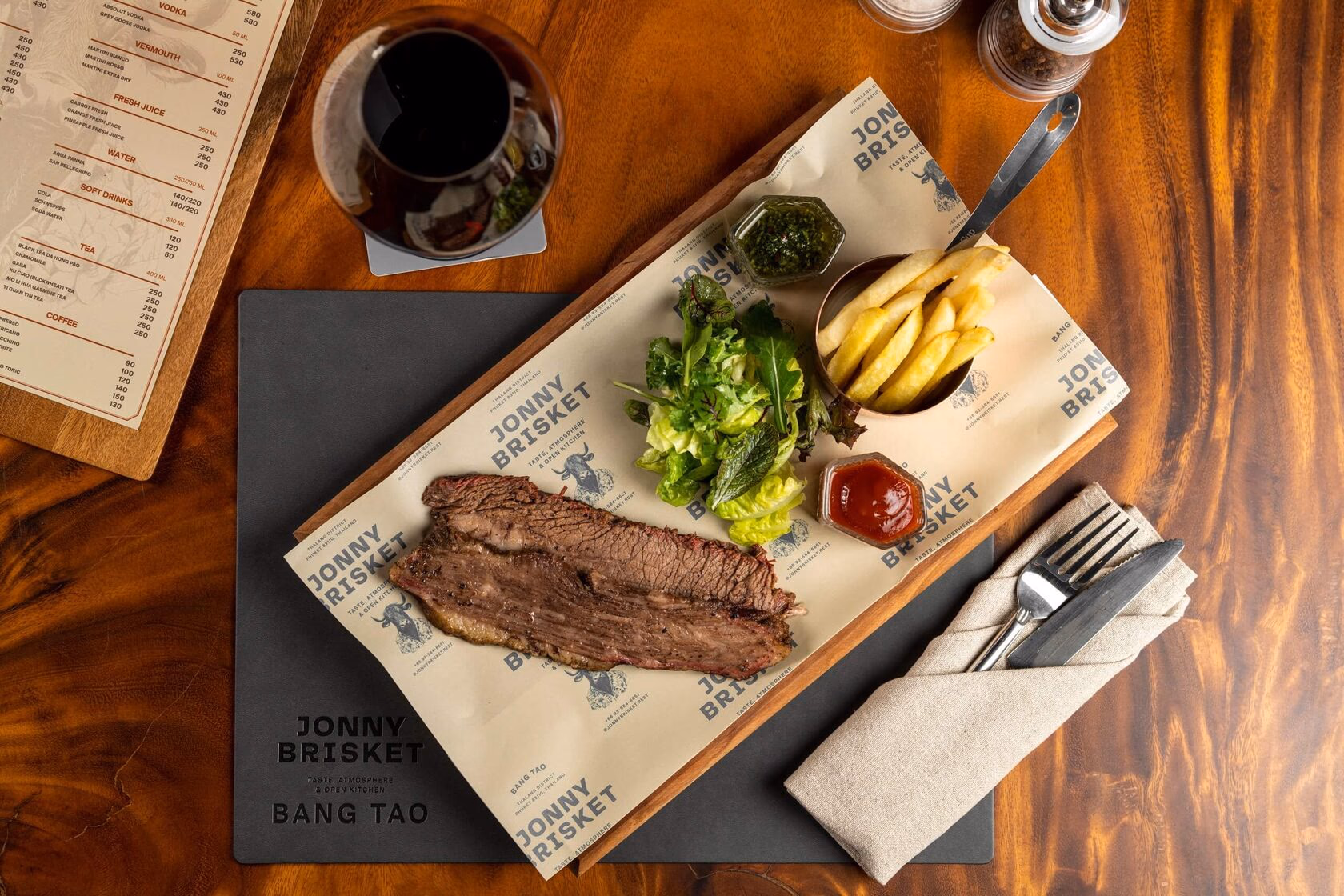 Steak on a wooden board with greens
